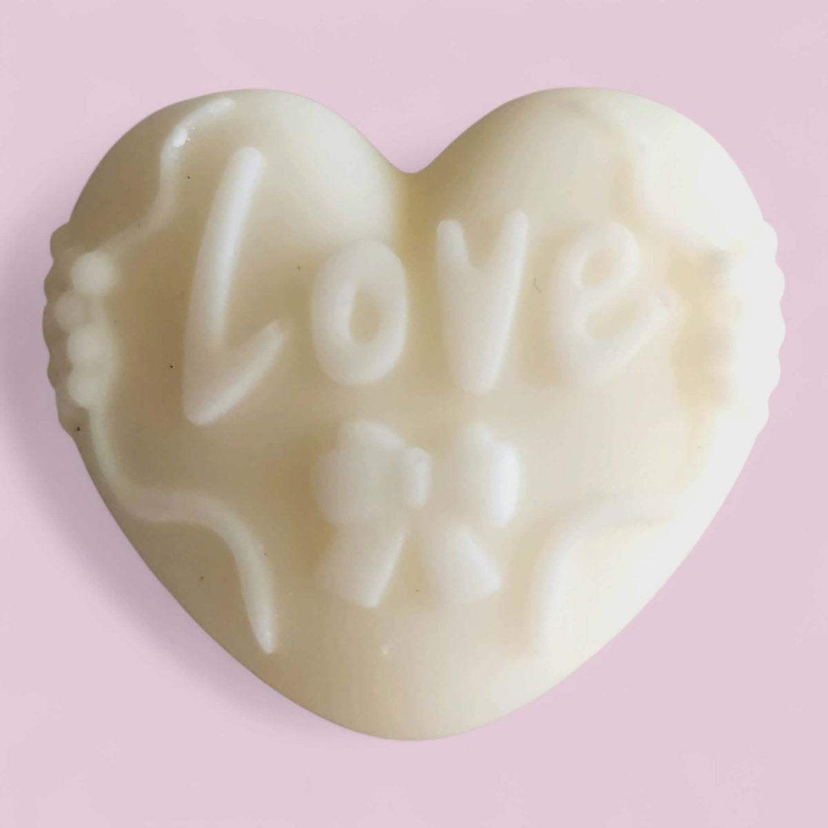 Heart-shaped melt with 'LOVE' and heart designs on a pink background